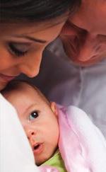 parents holding their baby